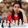 A girl in a red shirt playing chess